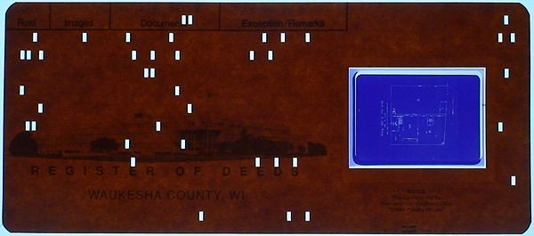 Photo of a punched card containing a microfilm image